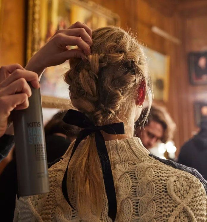 Woman at fashion show with bow in her hair