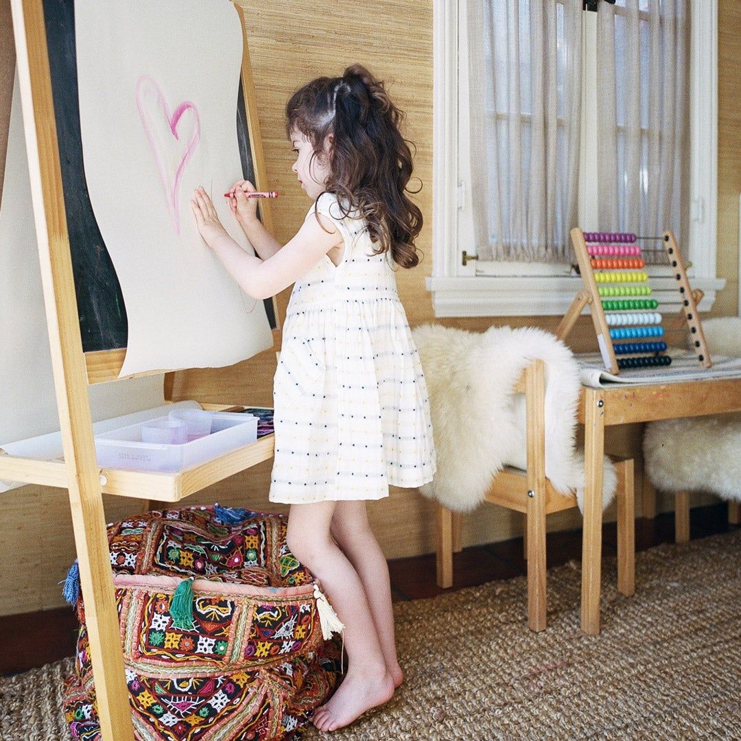 child painting at an easel