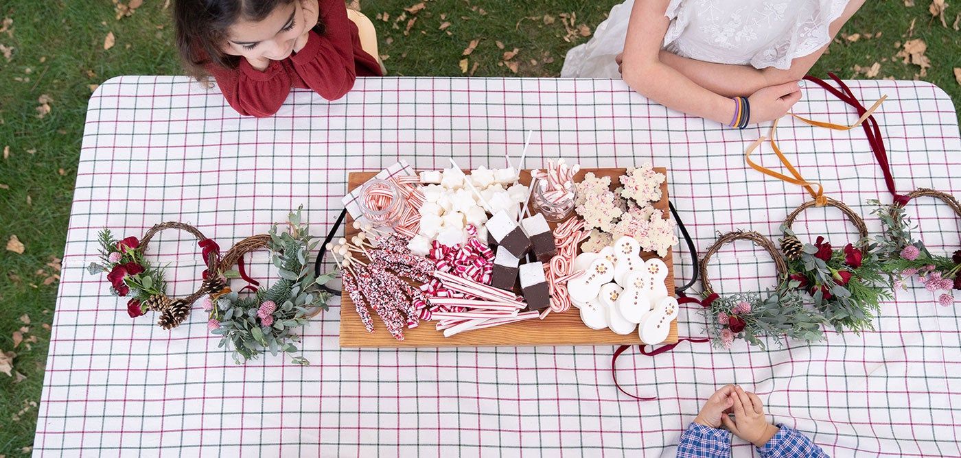 hot chocolate and holiday candy on a holiday craft party table