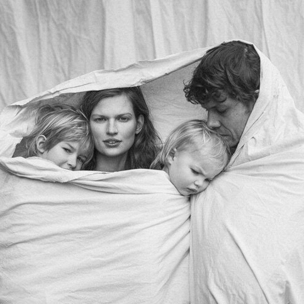 Black and White Photo of family wrapped in a sheet