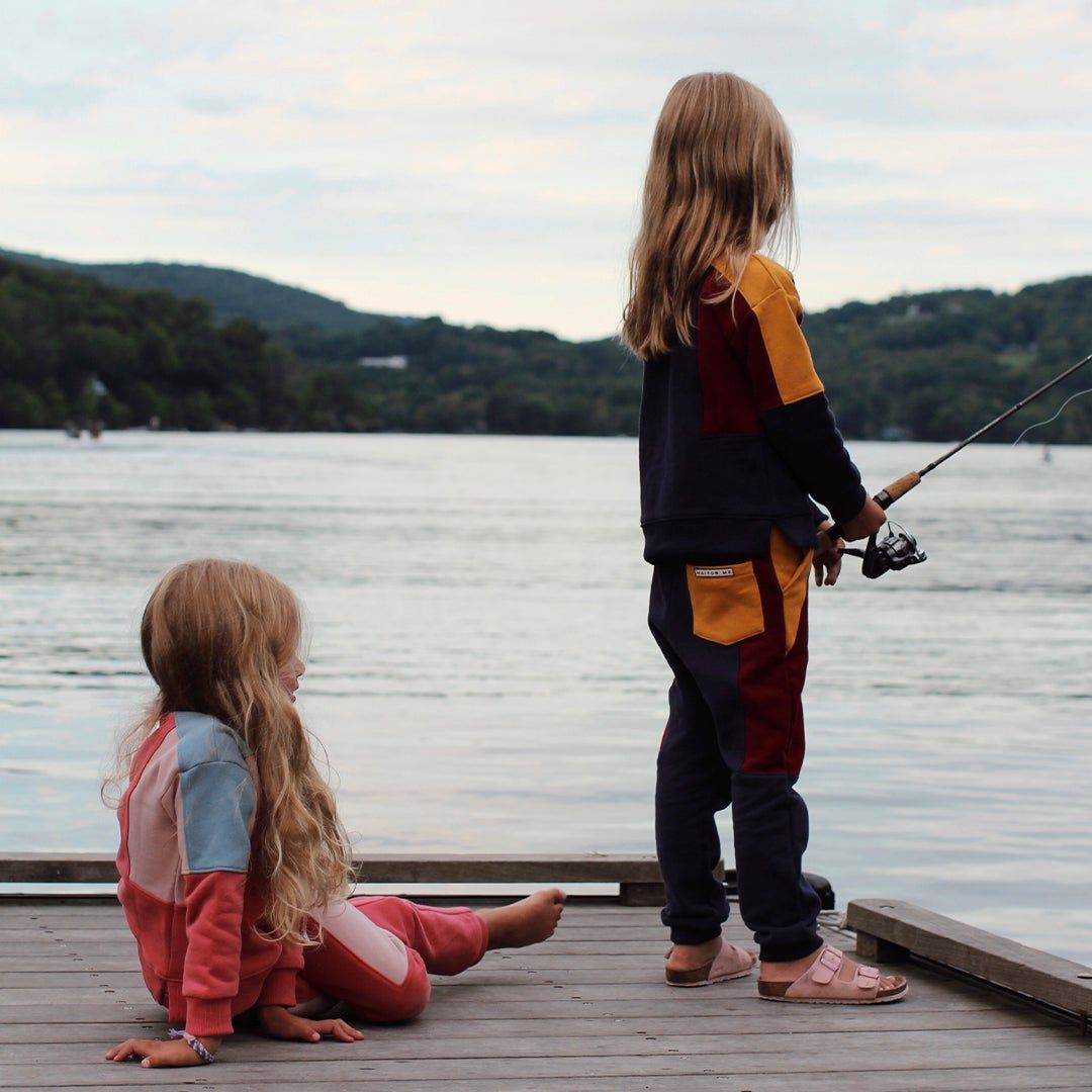 photo of two children on a dock wearing Maison Me sweatsuits and fishing