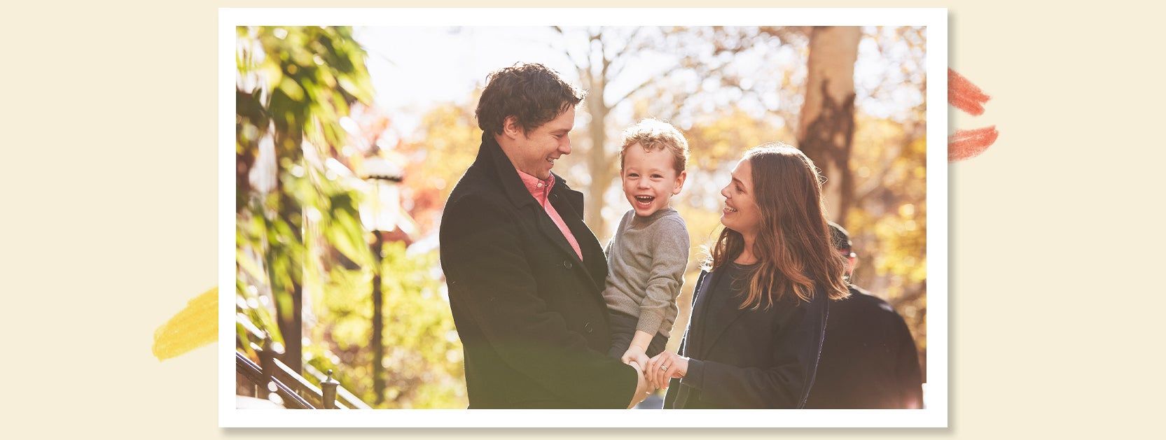 family smiling outside for a holiday card photo