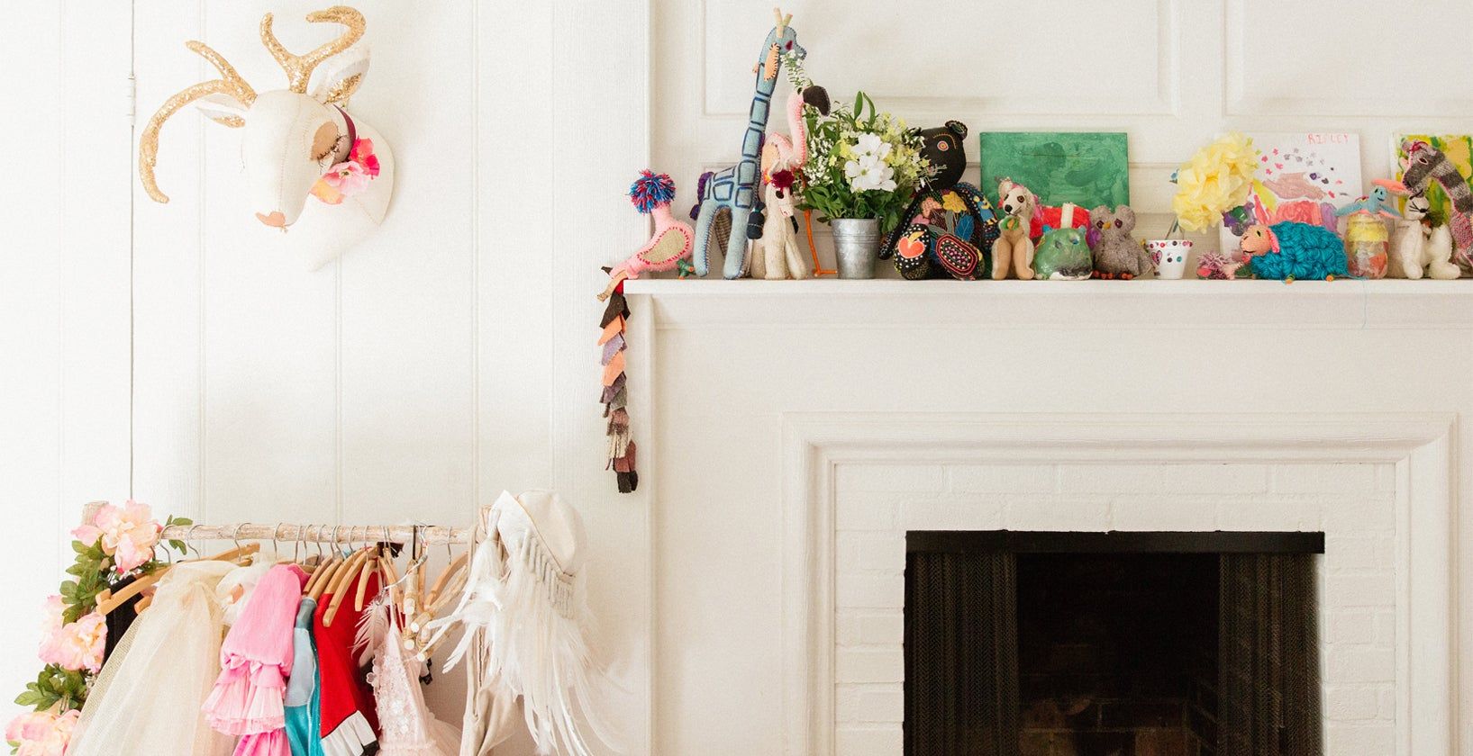 Jenni Kayne's home with fireplace mantel lined with toys and dress up clothes