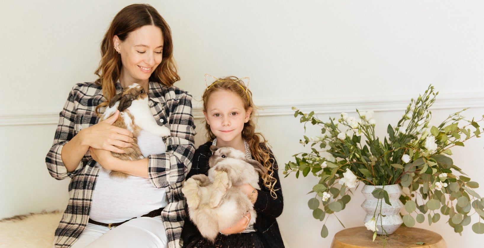 Jenni Kayne and her daughter holding their pet bunnies at home