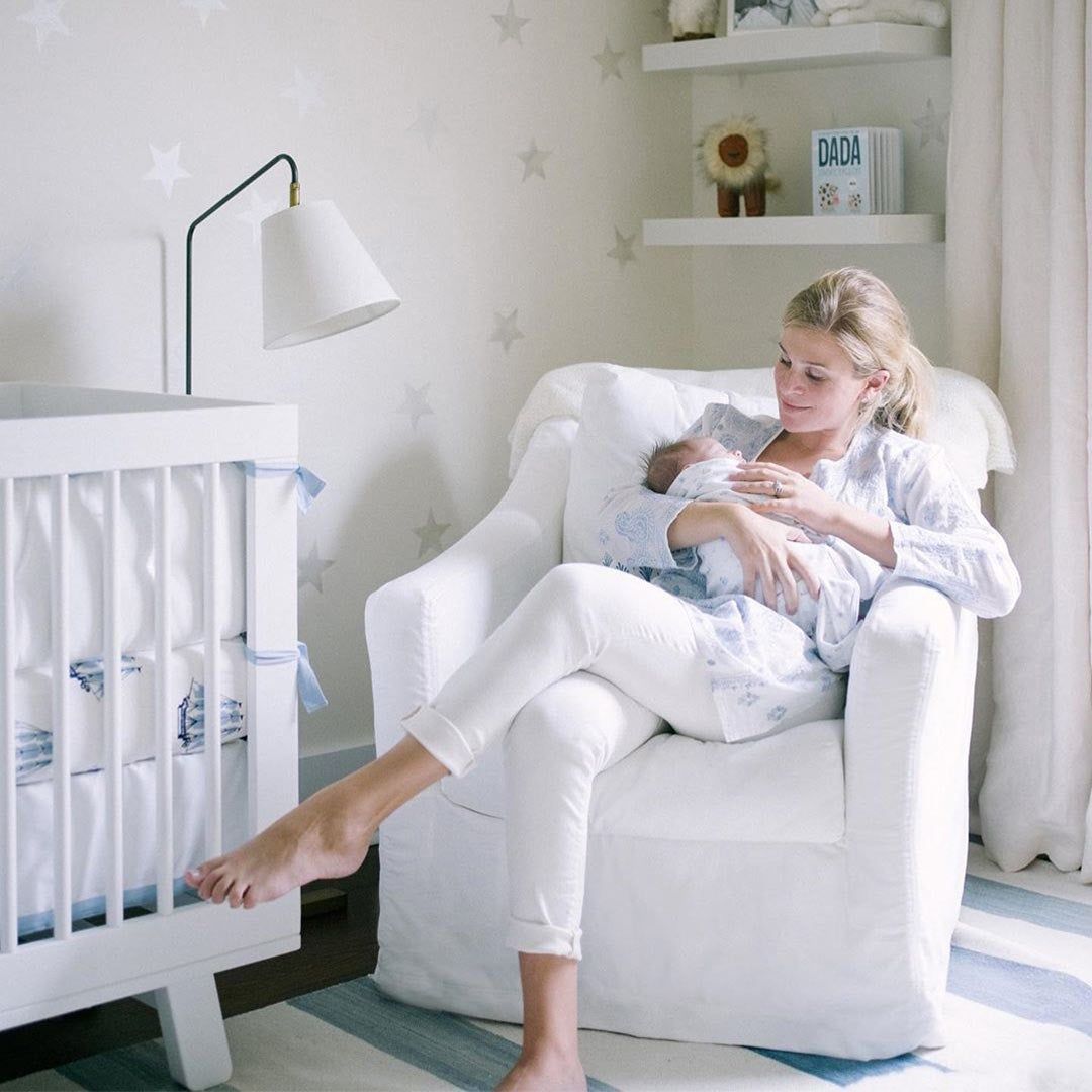 Lucy Cuneo with her infant in a rocker 