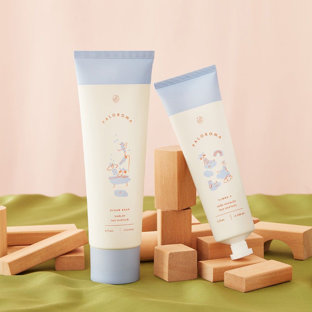 On the left is an image of two products from the kids skincare brand, Paloroma. The products, Clean Bean and Cloud 9 rest on a green and cream still life set up of wooden blocks. On the right is an image of co-founder, Jane Keltner de Valle's children Roman and Paloma.