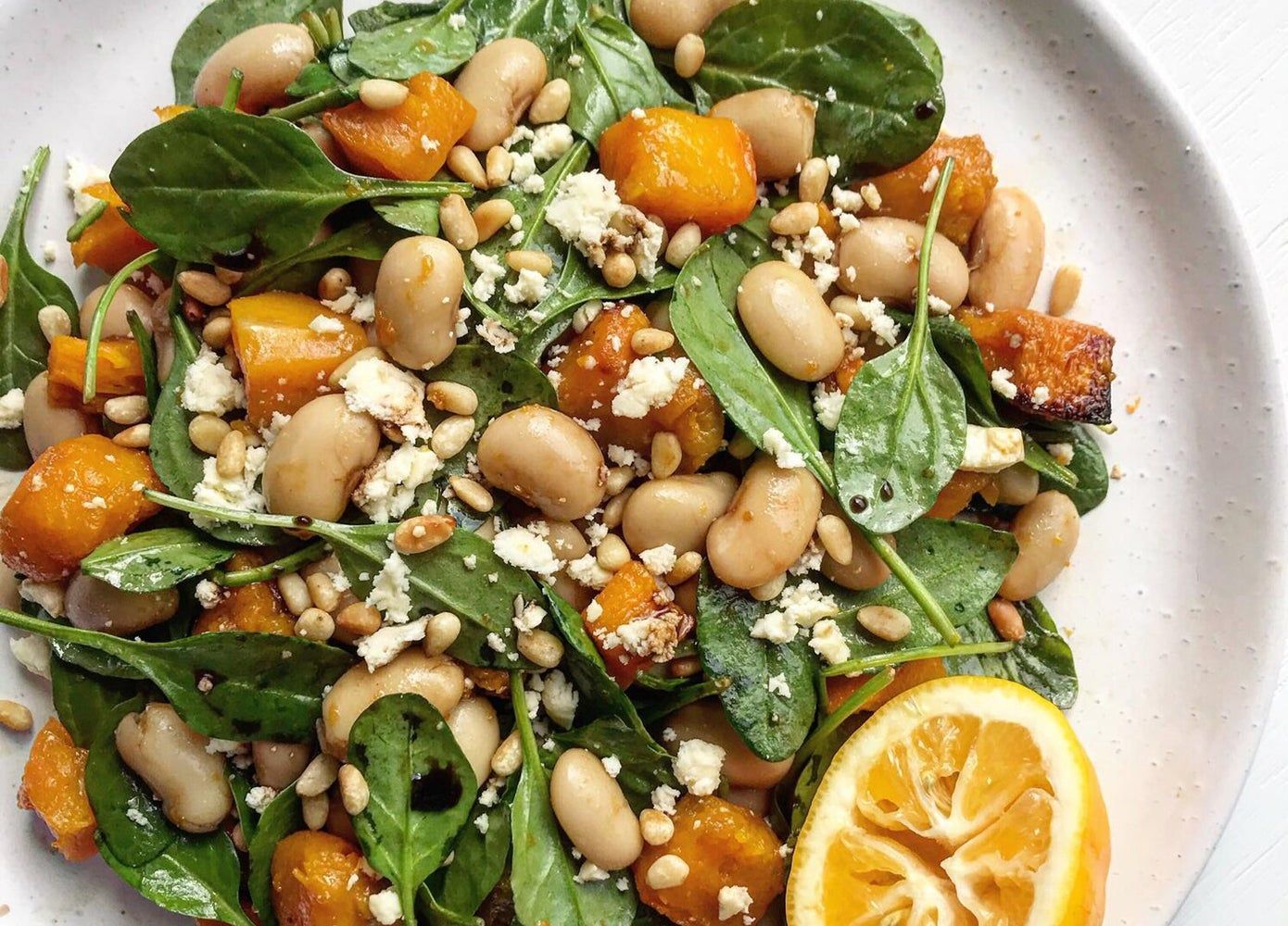 Overhead photo of a salad with cannellini beans, feta, pumpkin chunks and sunflower seeds