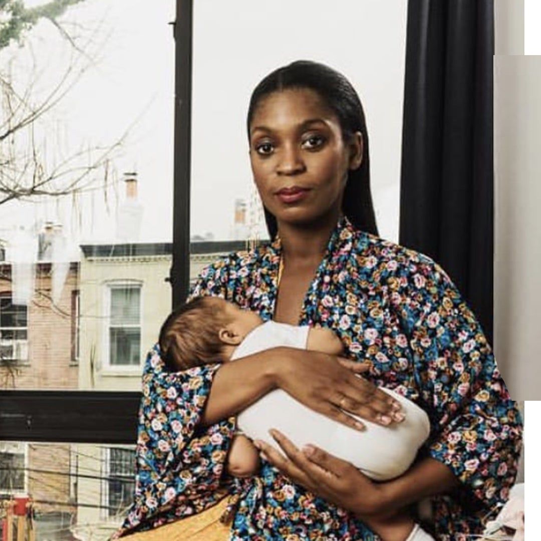 Rajni Jacques against a window with her infant