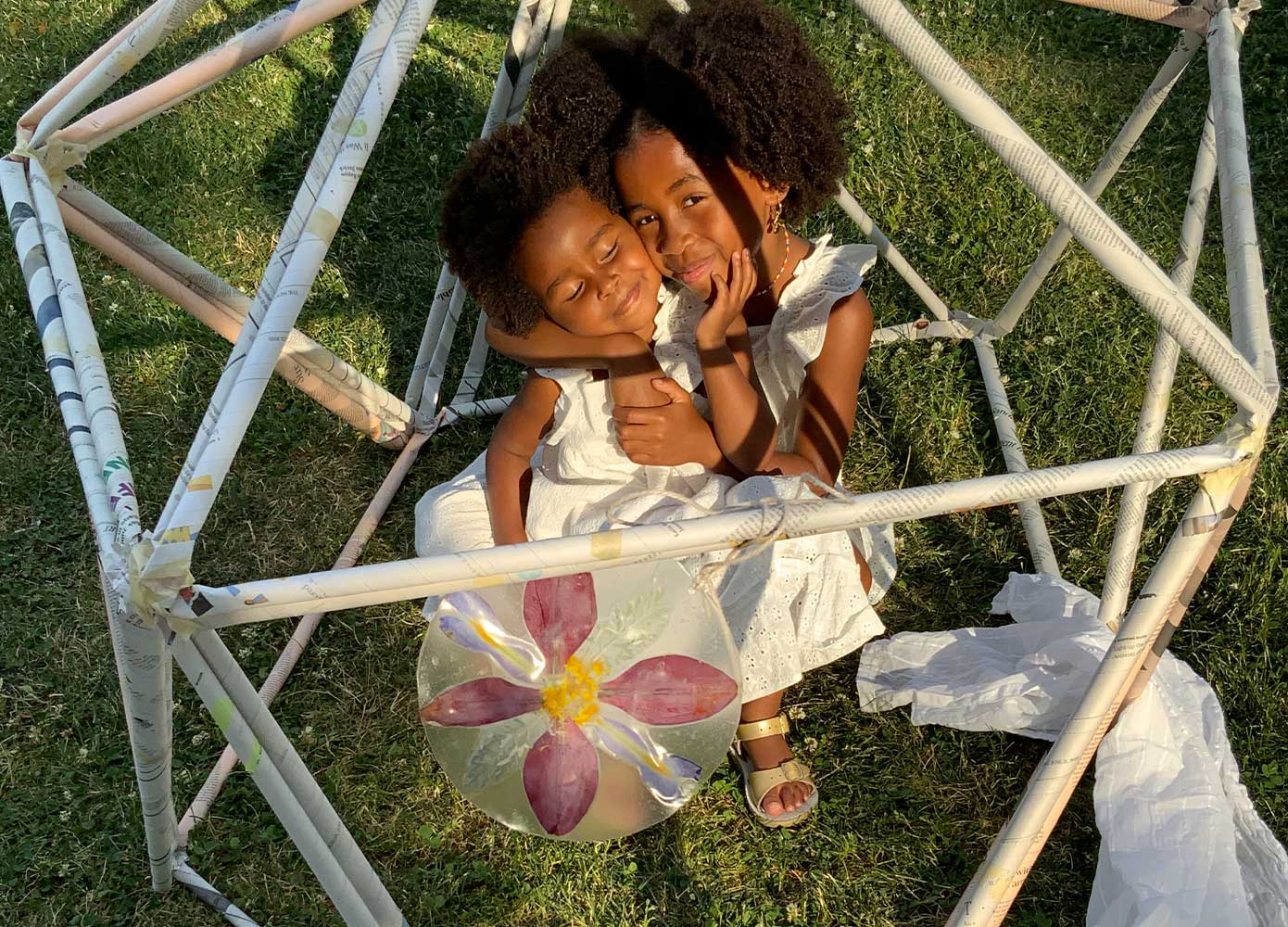 two children holding a nature suncatcher