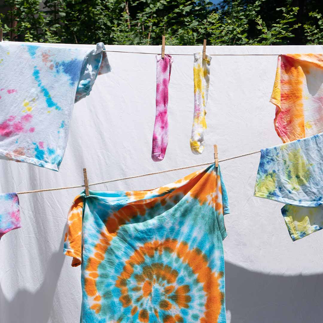 tie-dyed clothes hanging on a clothes line