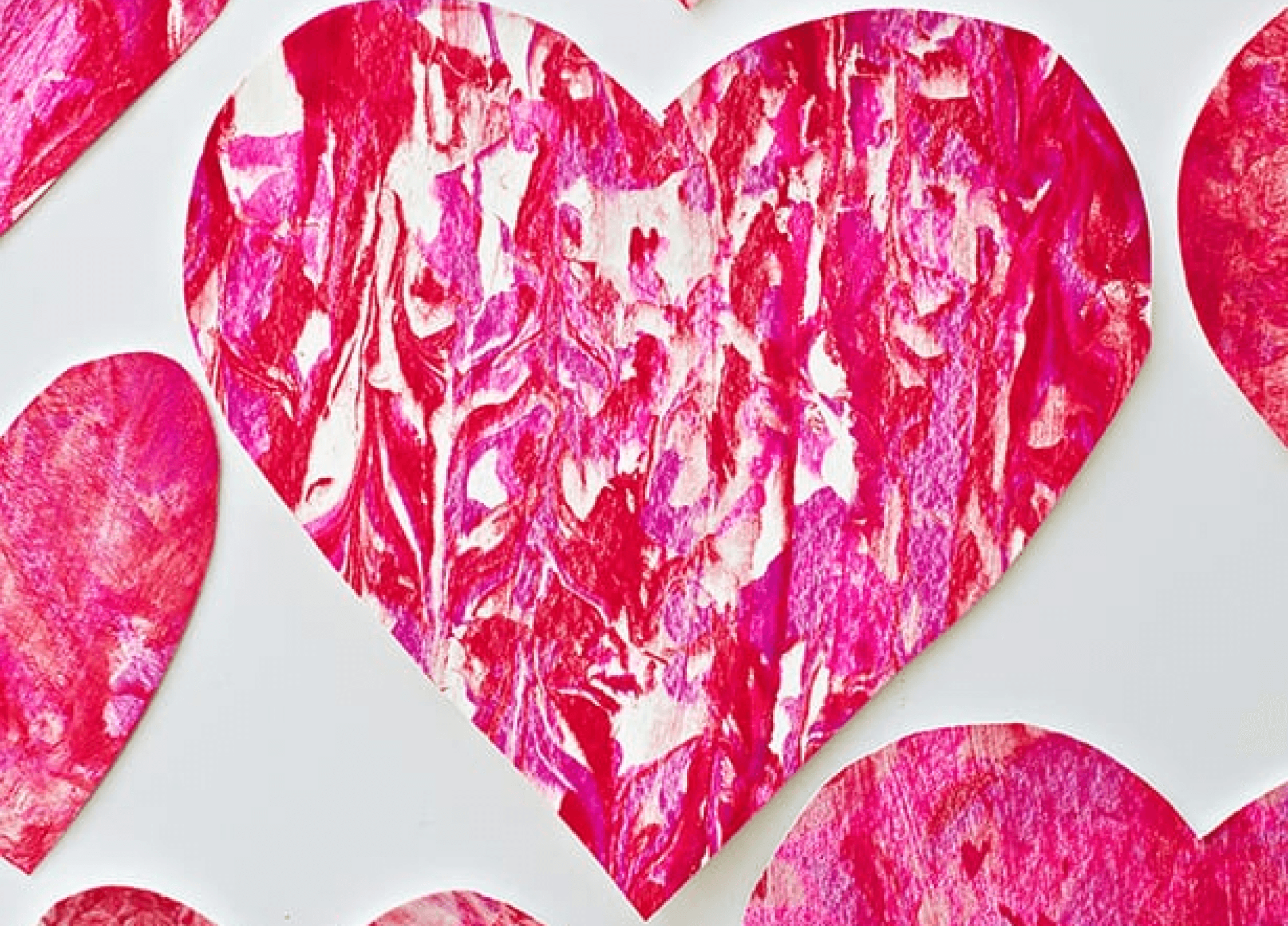 Painted puzzle pieces glued together to create a heart-shaped wreath