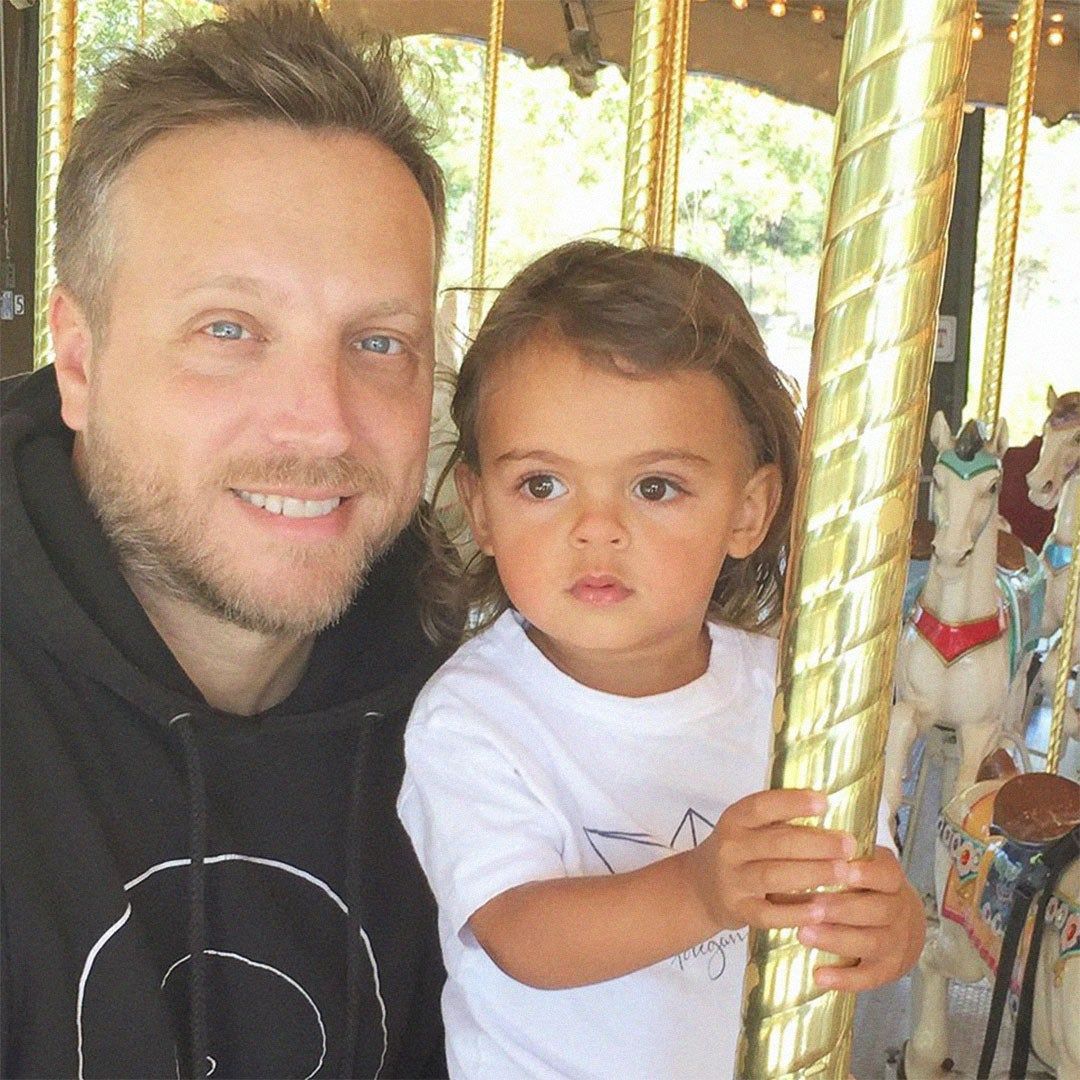Ariel Foxman and his son on a carousel