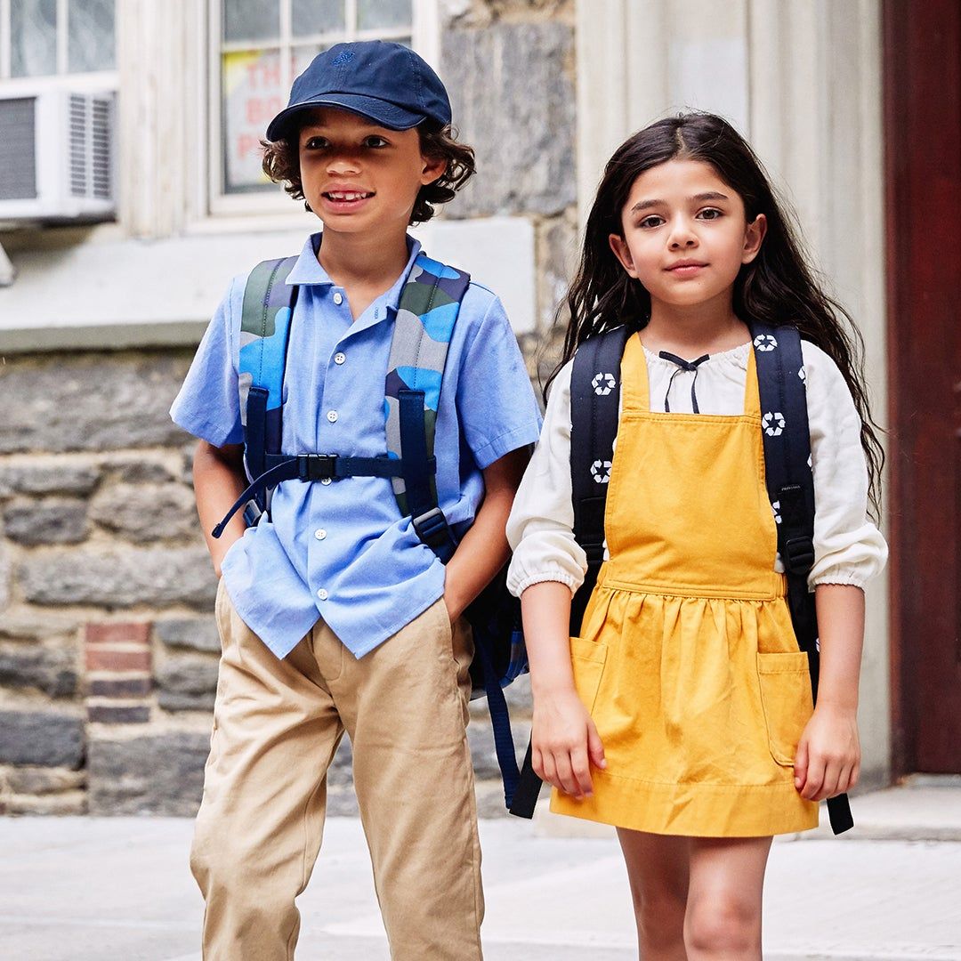 kids walking into school with backpacks