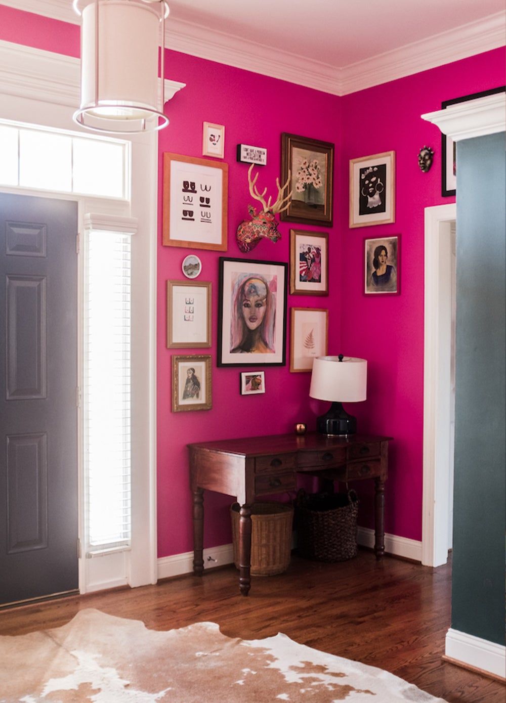 a small table against a bright pink wall