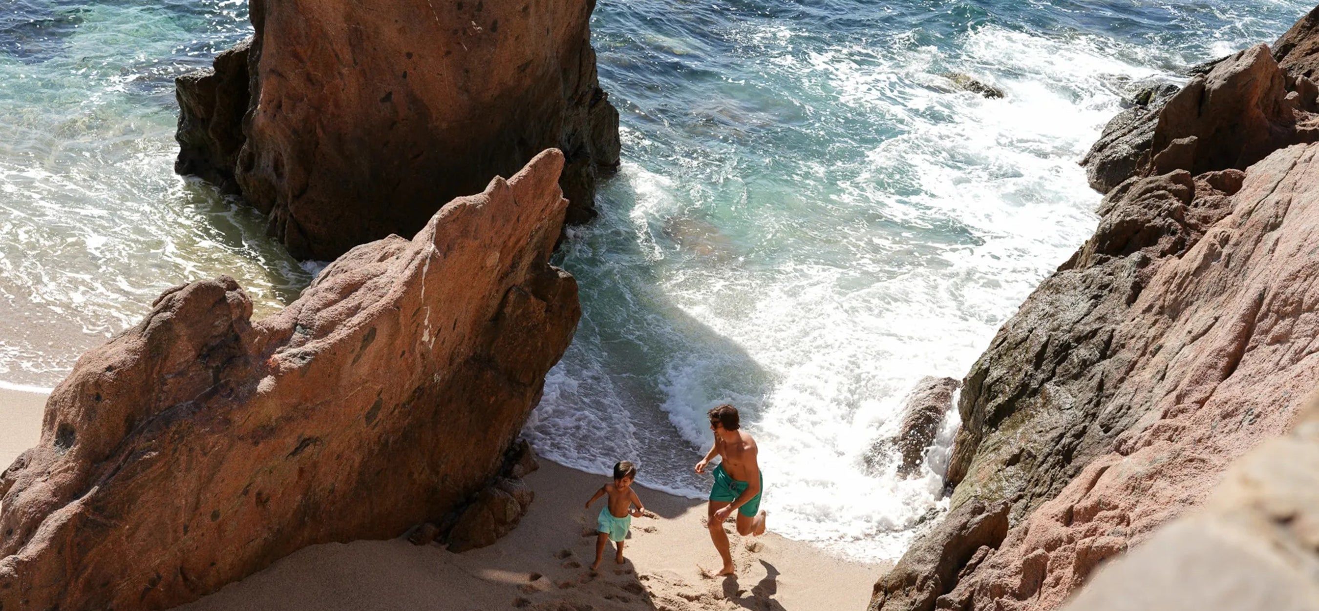 toddler on the beach under a sun shade while on vacation