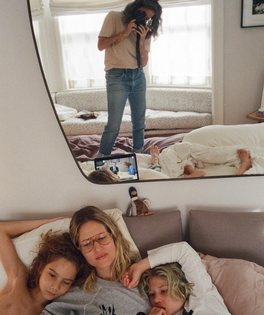 Photographer Cass Bird photographing her family in a mirror