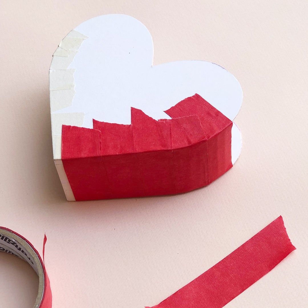 covering heart box with red tape