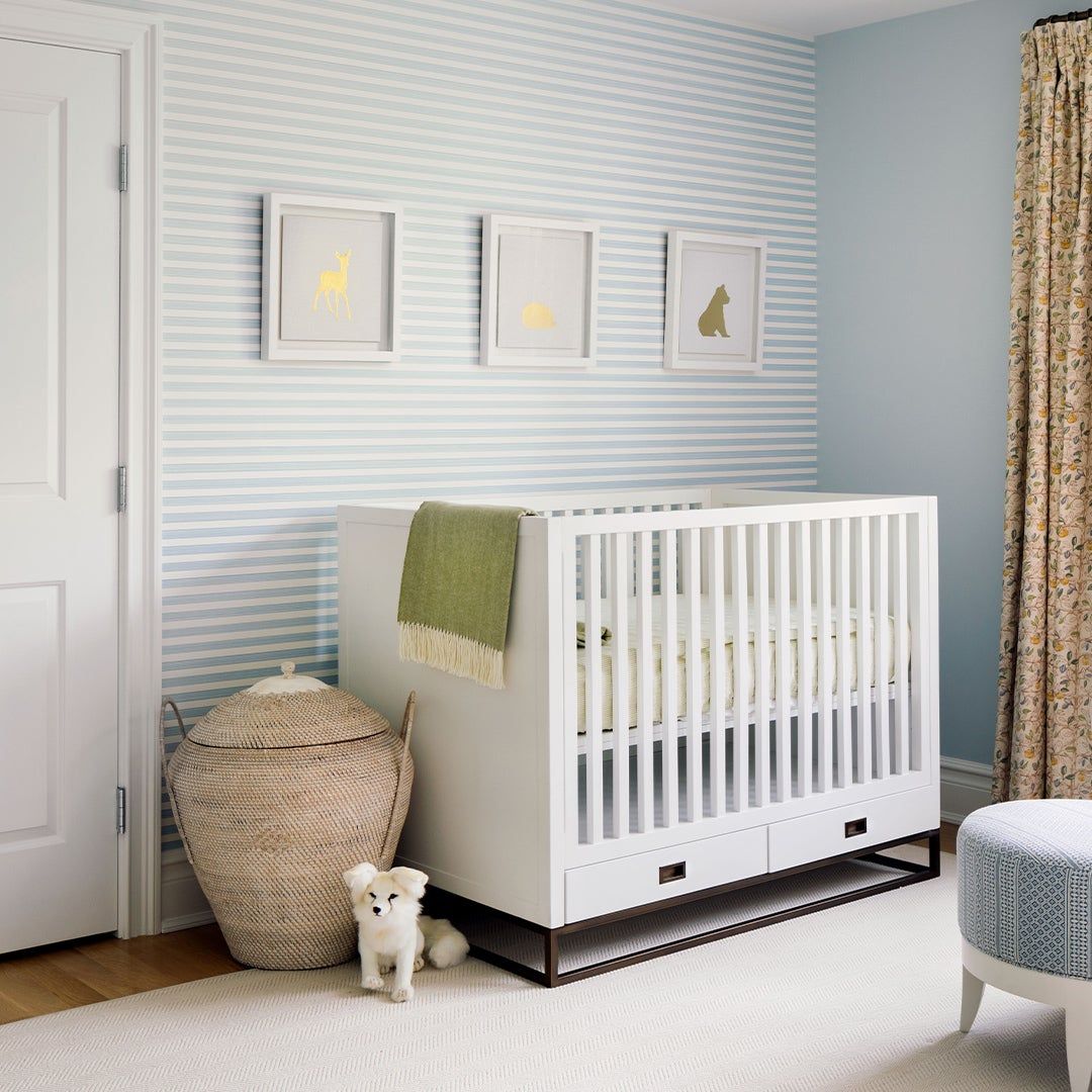 crib in front of a pale blue wall