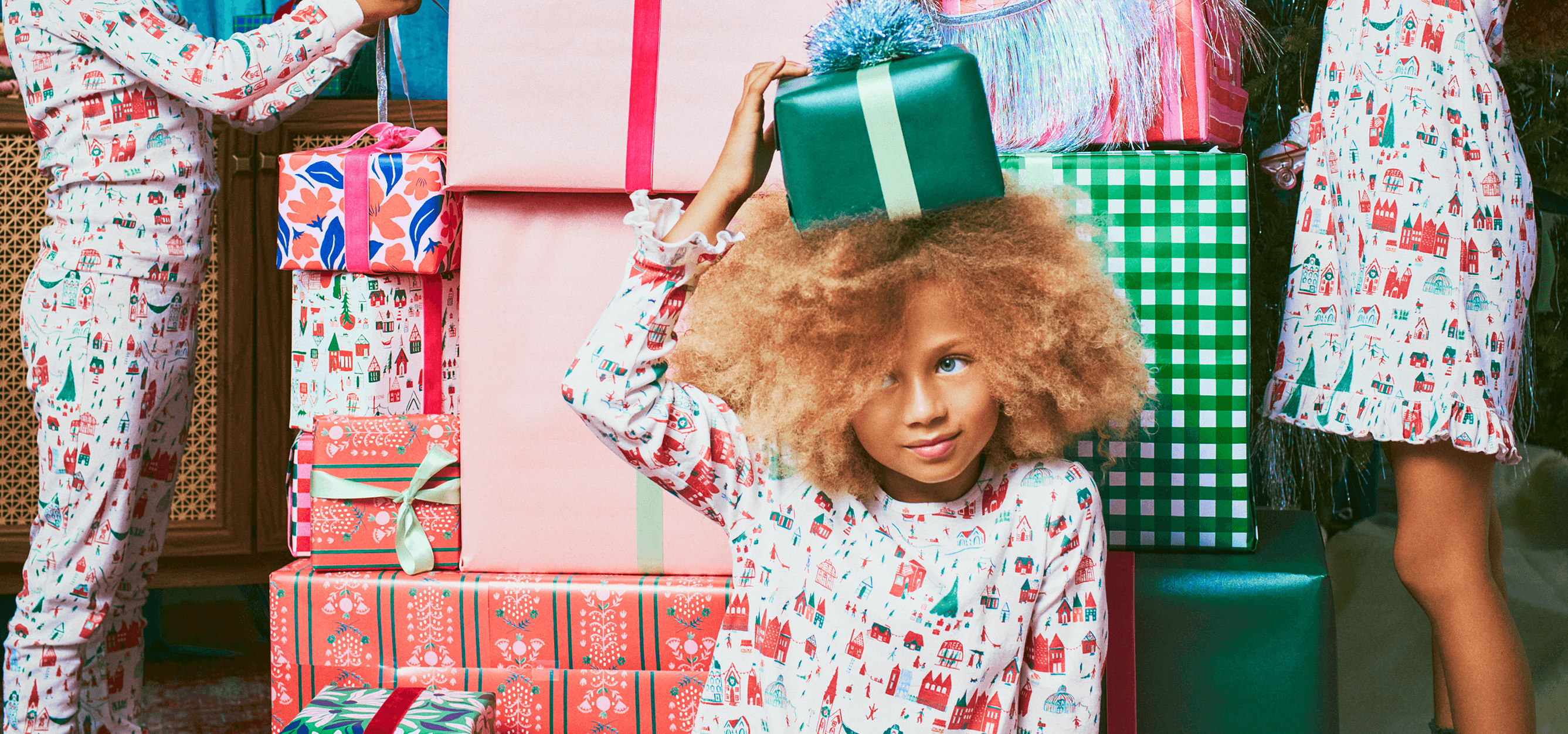 kids in front of presents and Christmas tree