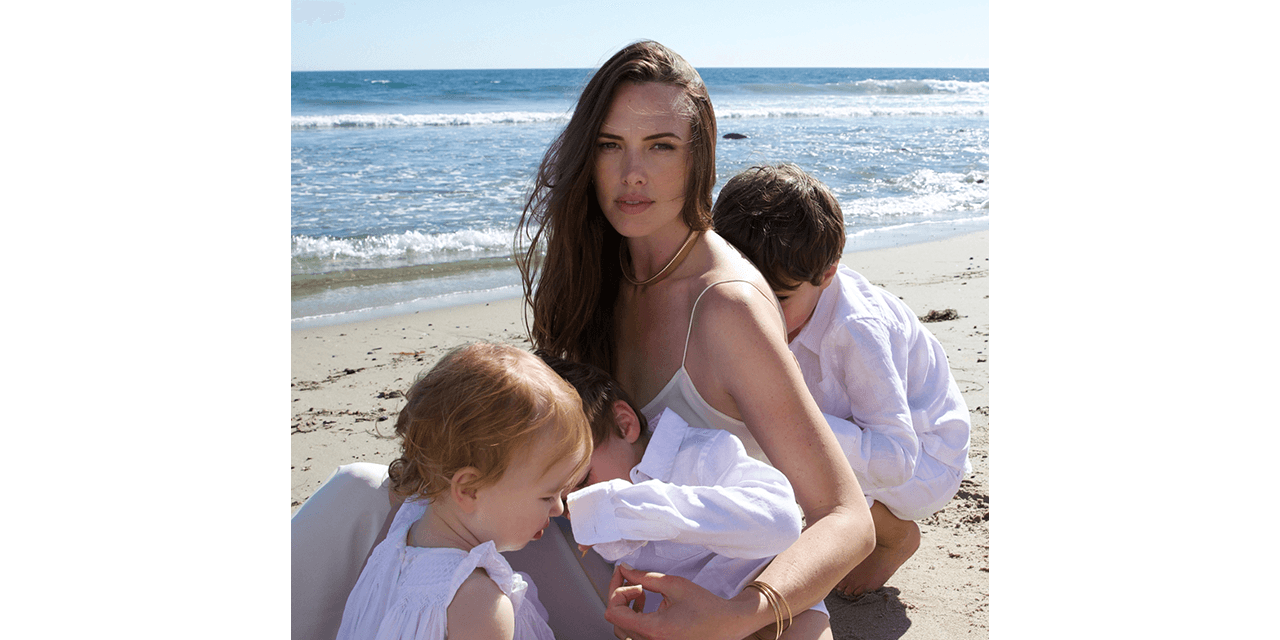 Claire Khodara and her three children on the beach