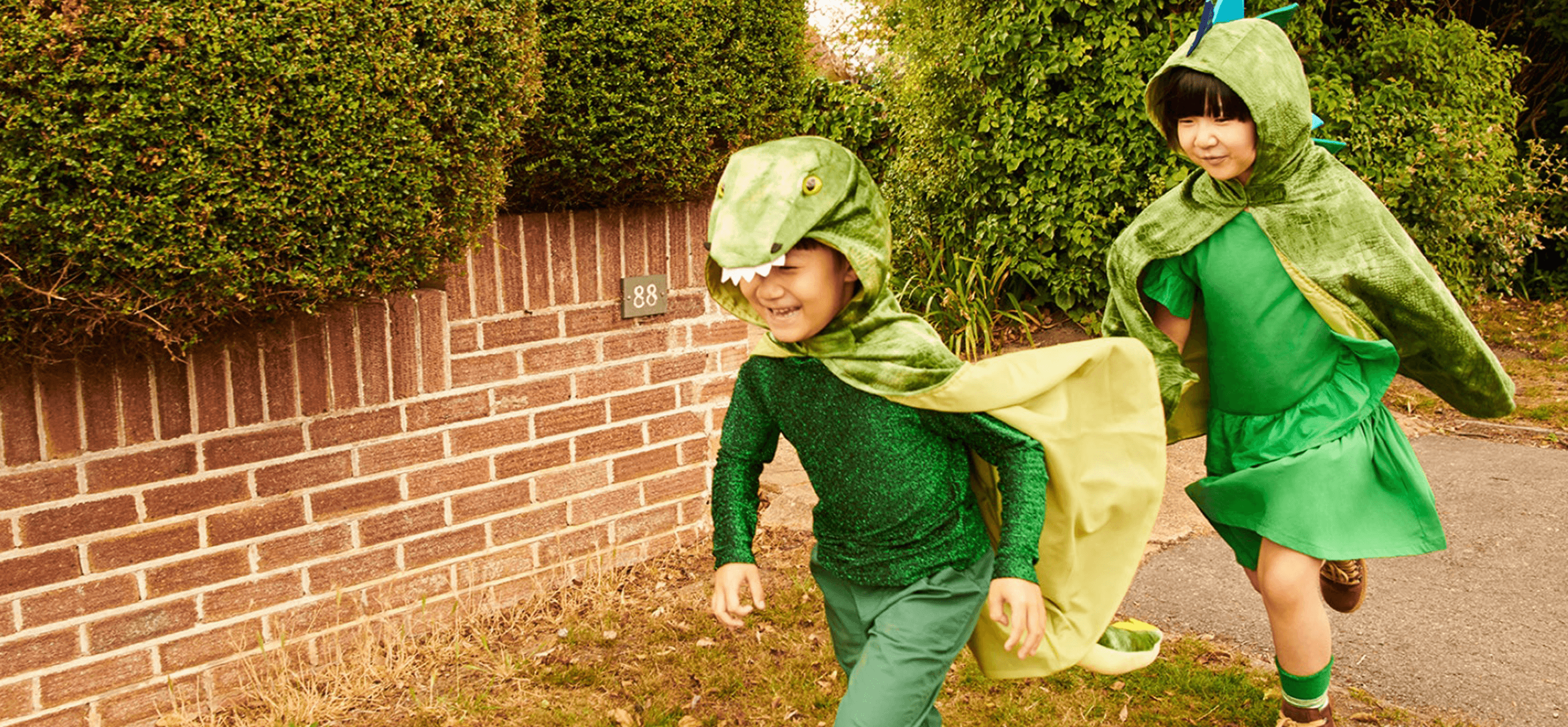 kids running around in dinosaur costumes