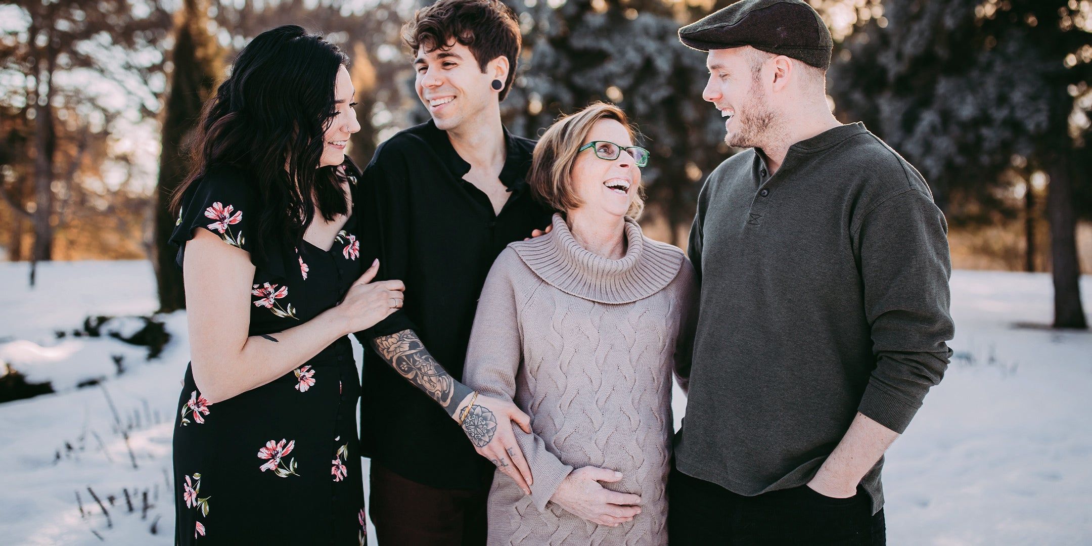 four adult children standing with their pregnant middle-aged mother