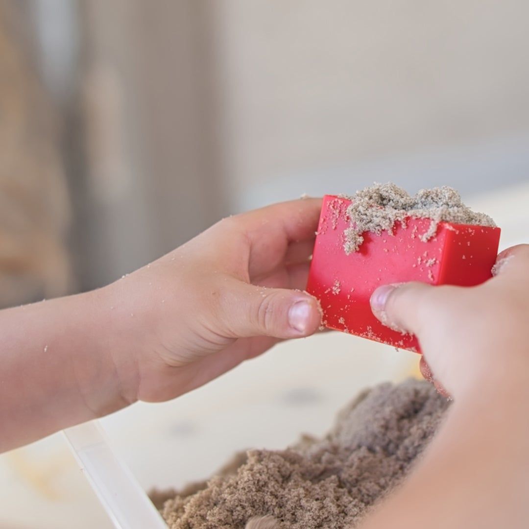 toddler playing with kinetic sand