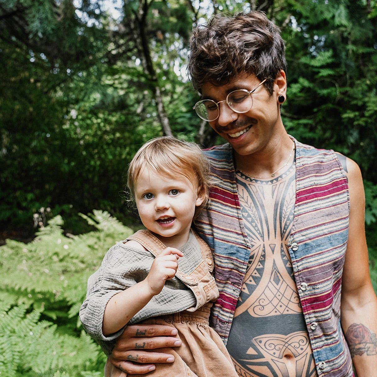 Eliot Durt holding his daughter Uma in the woods