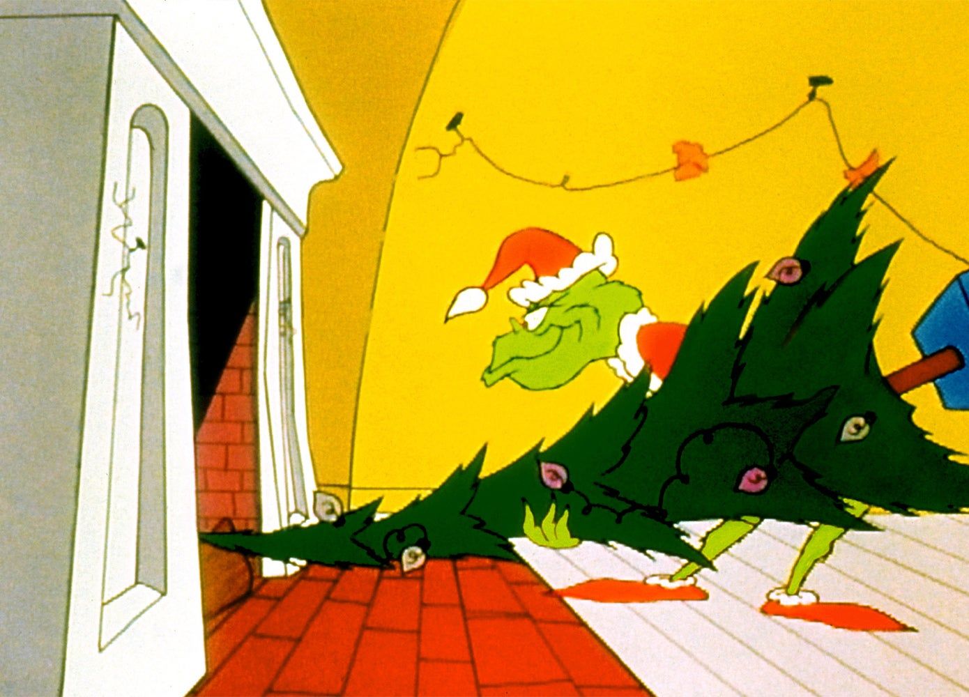 A still from "How the Grinch Stole Christmas" showing the Grinch stealing a Christmas tree