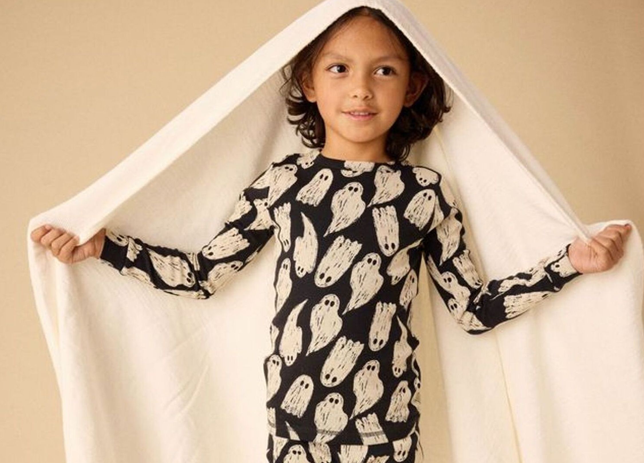 Child wearing ghost-themed pajamas.