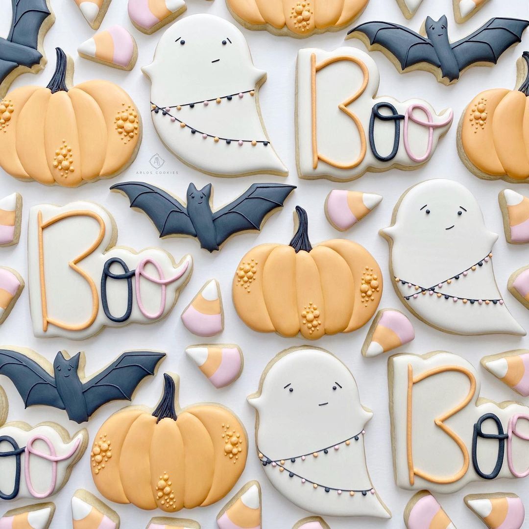 cute Halloween treats - sugar cookies with royal icing bat, pumpkin, ghost, candy corn shapes