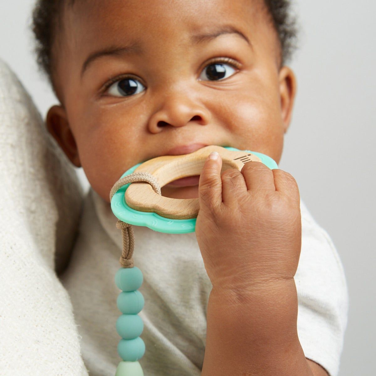Close up of baby chewing on teething ring