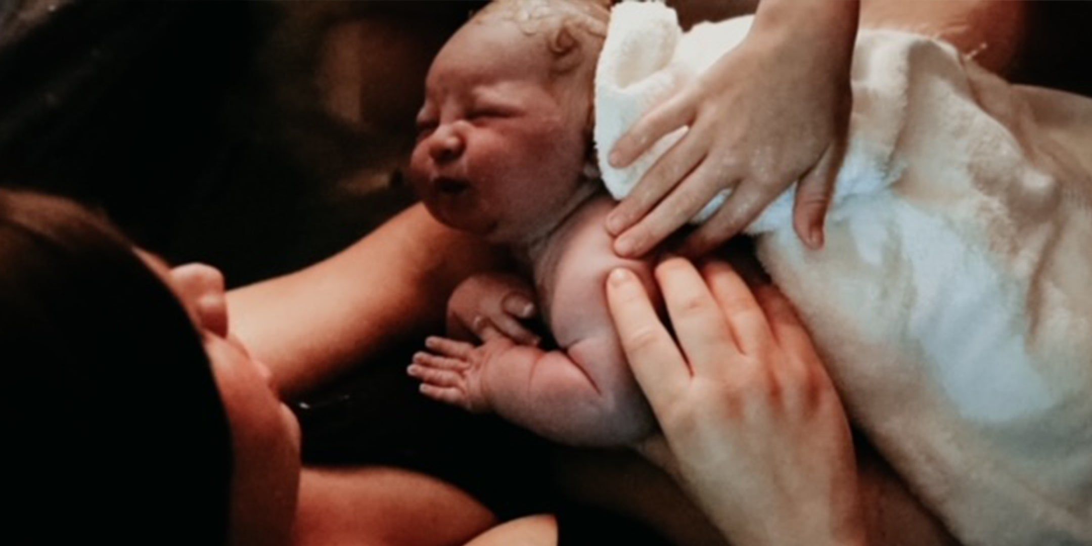 mother and her newborn baby after giving birth at home