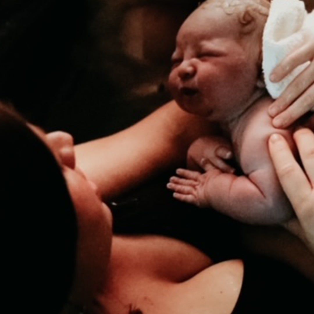 mother and her newborn baby after giving birth at home