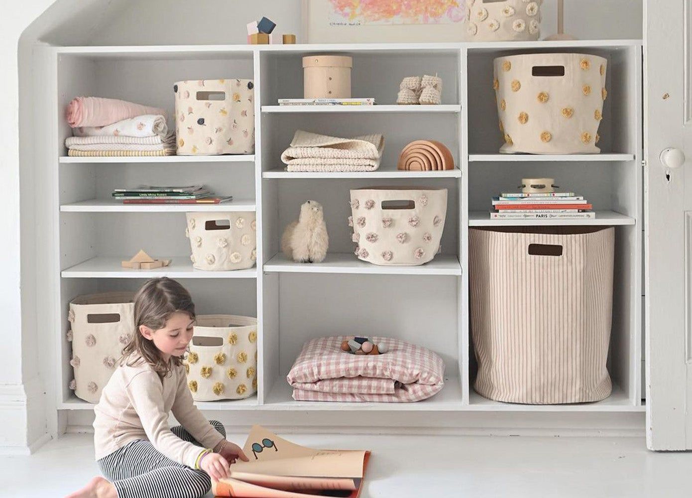 wall of built in shelving with Pehr baskets