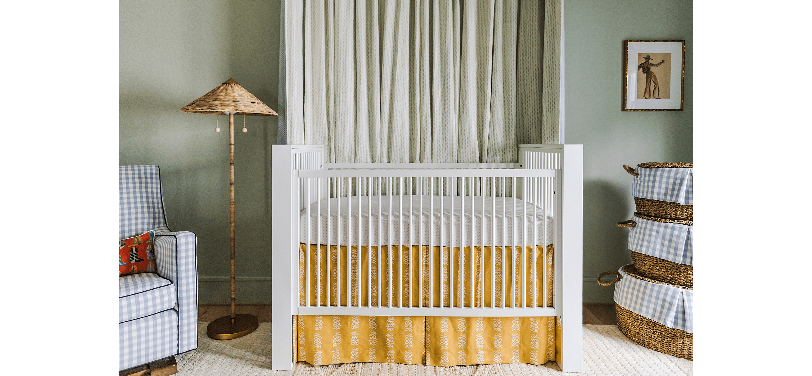 green painted nursery with white crib and wicker lamp