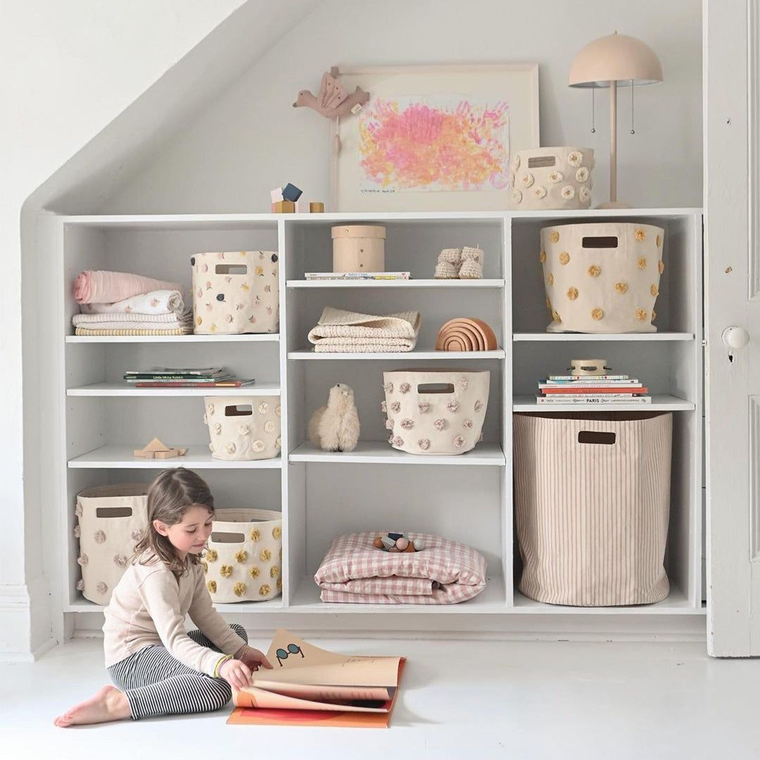 wall of built in shelving with Pehr baskets