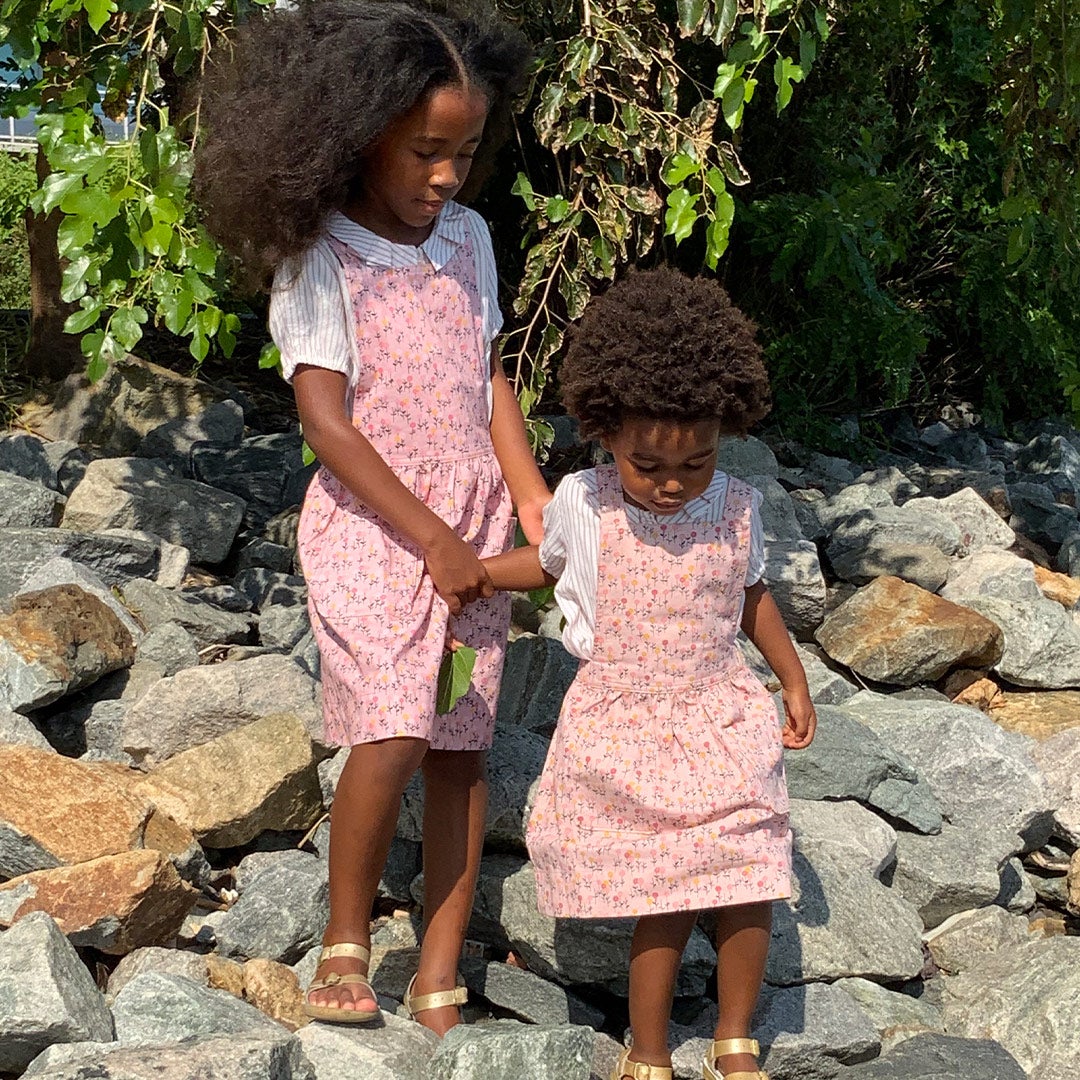 Lezi's daughters Indra and Nandi standing on rocks outside