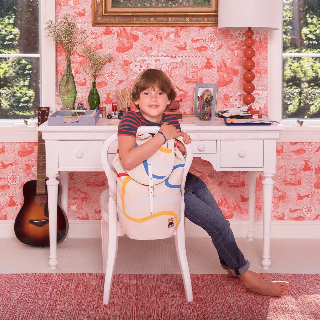 Child sitting at a desk, bedroom