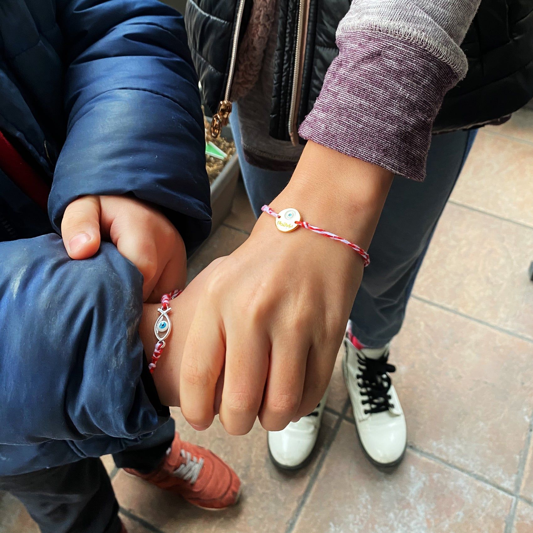 Eleni and her children wear their martakia bracelets