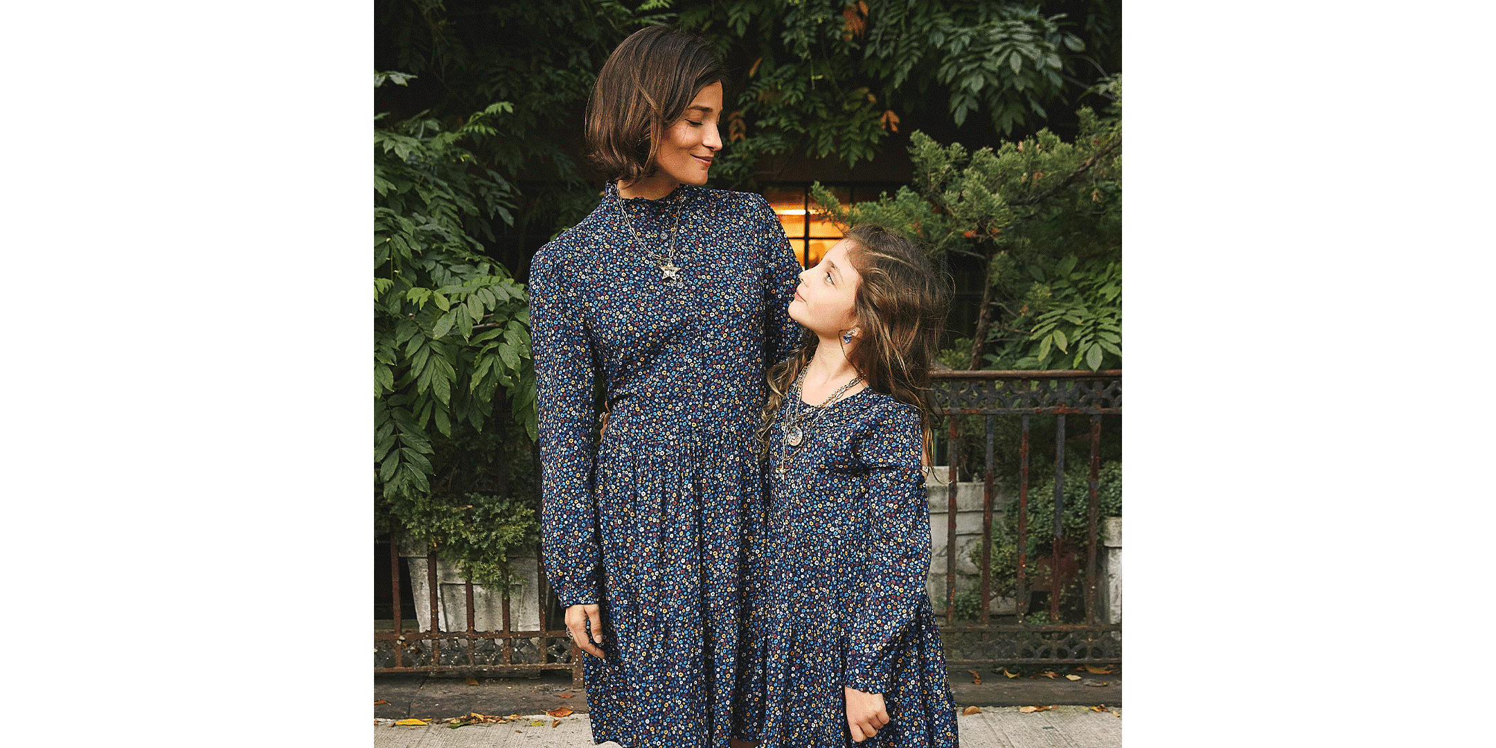 Maria and her daughter, Luna, standing outside in matching Maison Me dresses