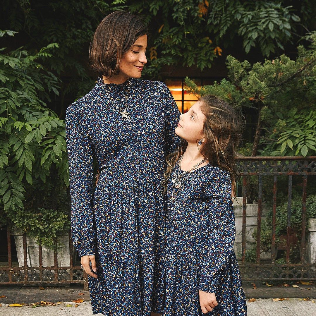 Maria and her daughter, Luna, standing outside in matching Maison Me dresses
