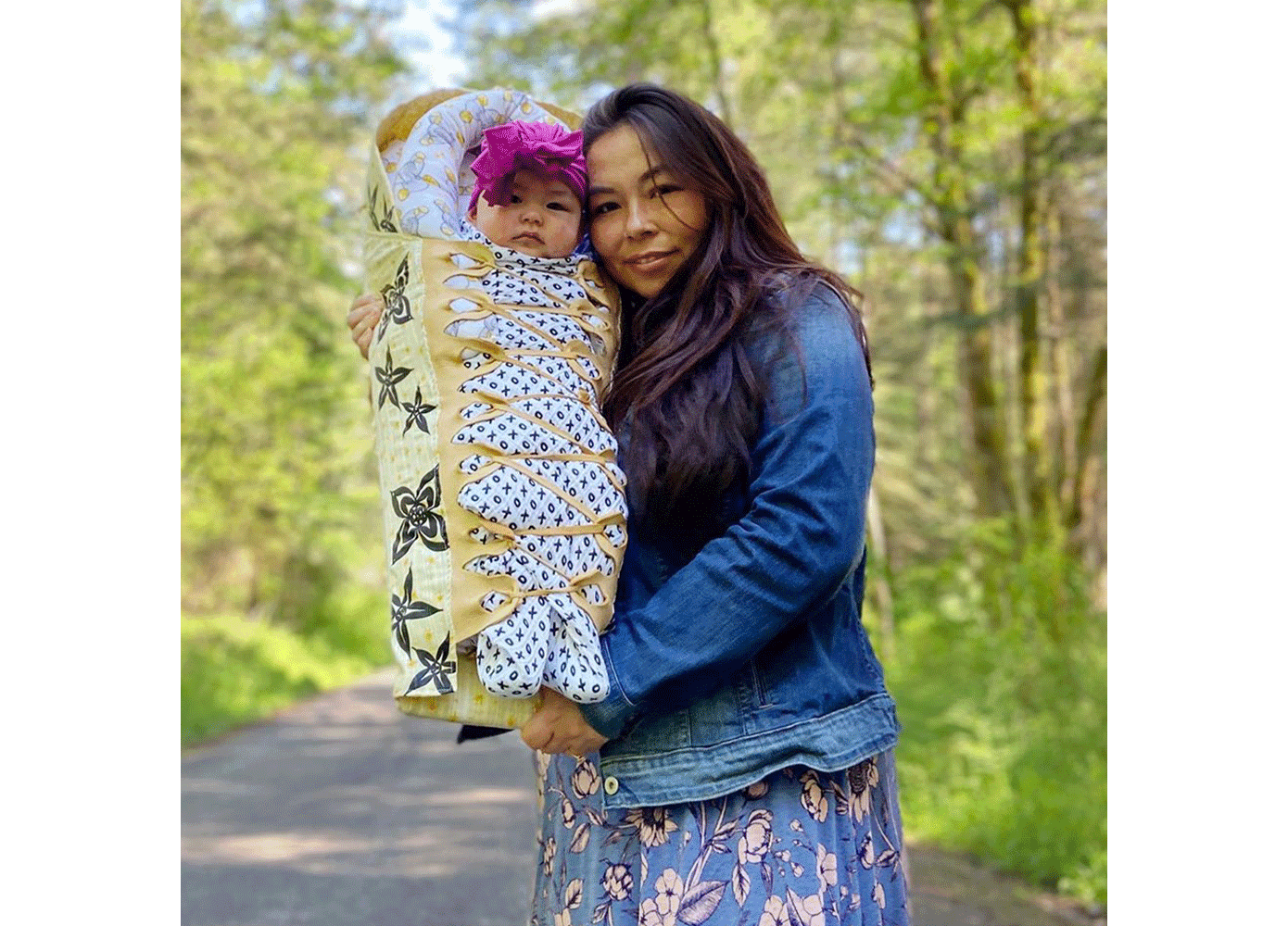 Matika Wilbur holding her daughter along a roadside