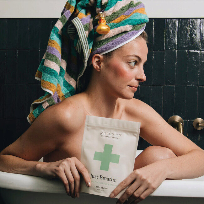 a mom in the bath with bath soak from her Christmas stocking
