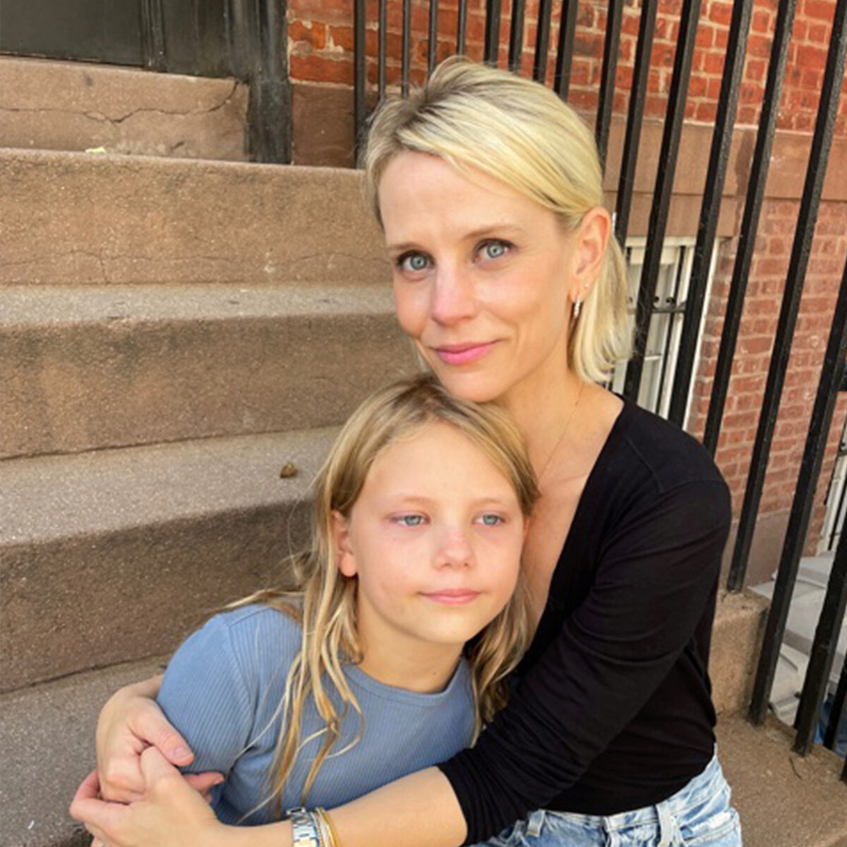 the author Jessica Harter with her daughter on a front stoop