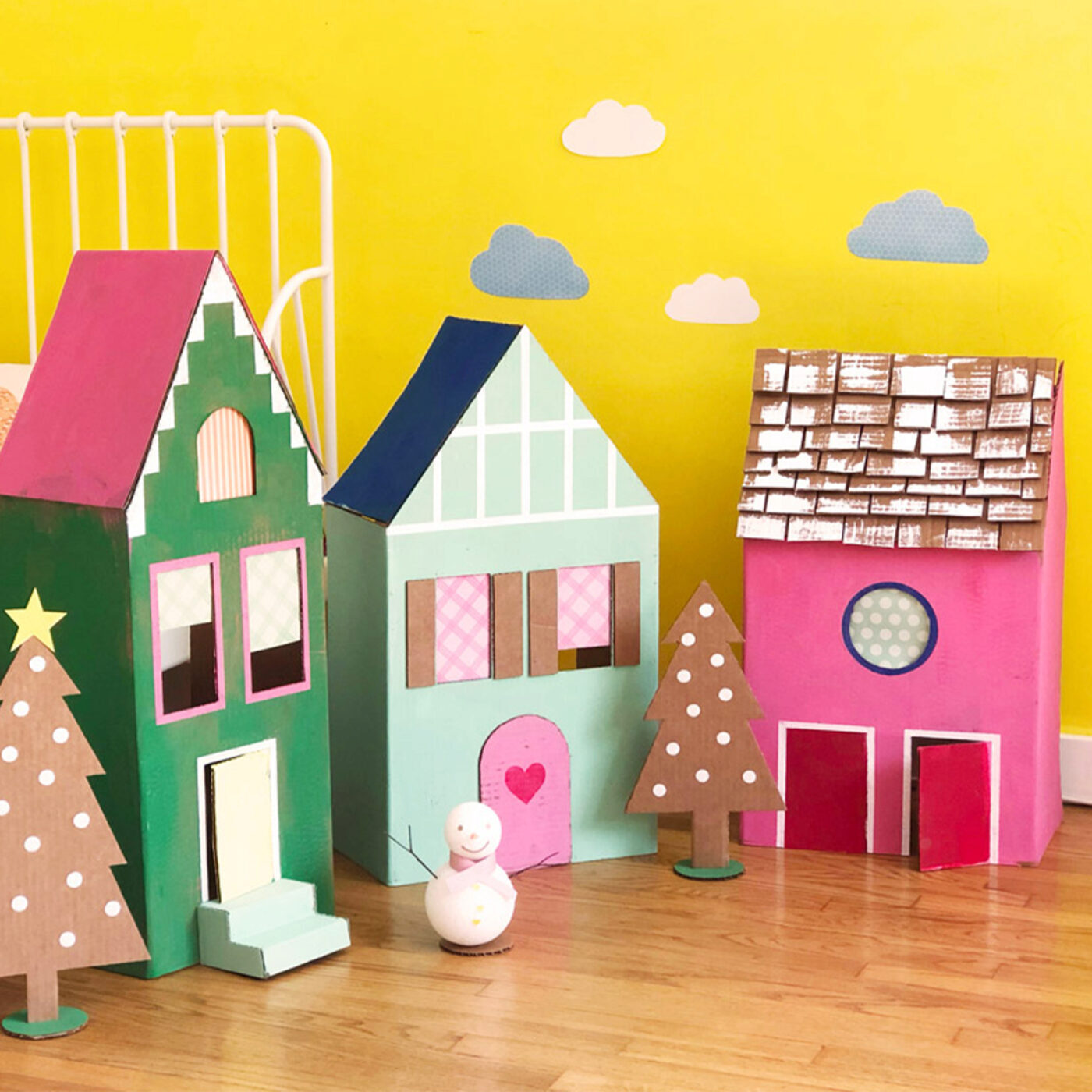 a village made of colorful painted cardboard box houses