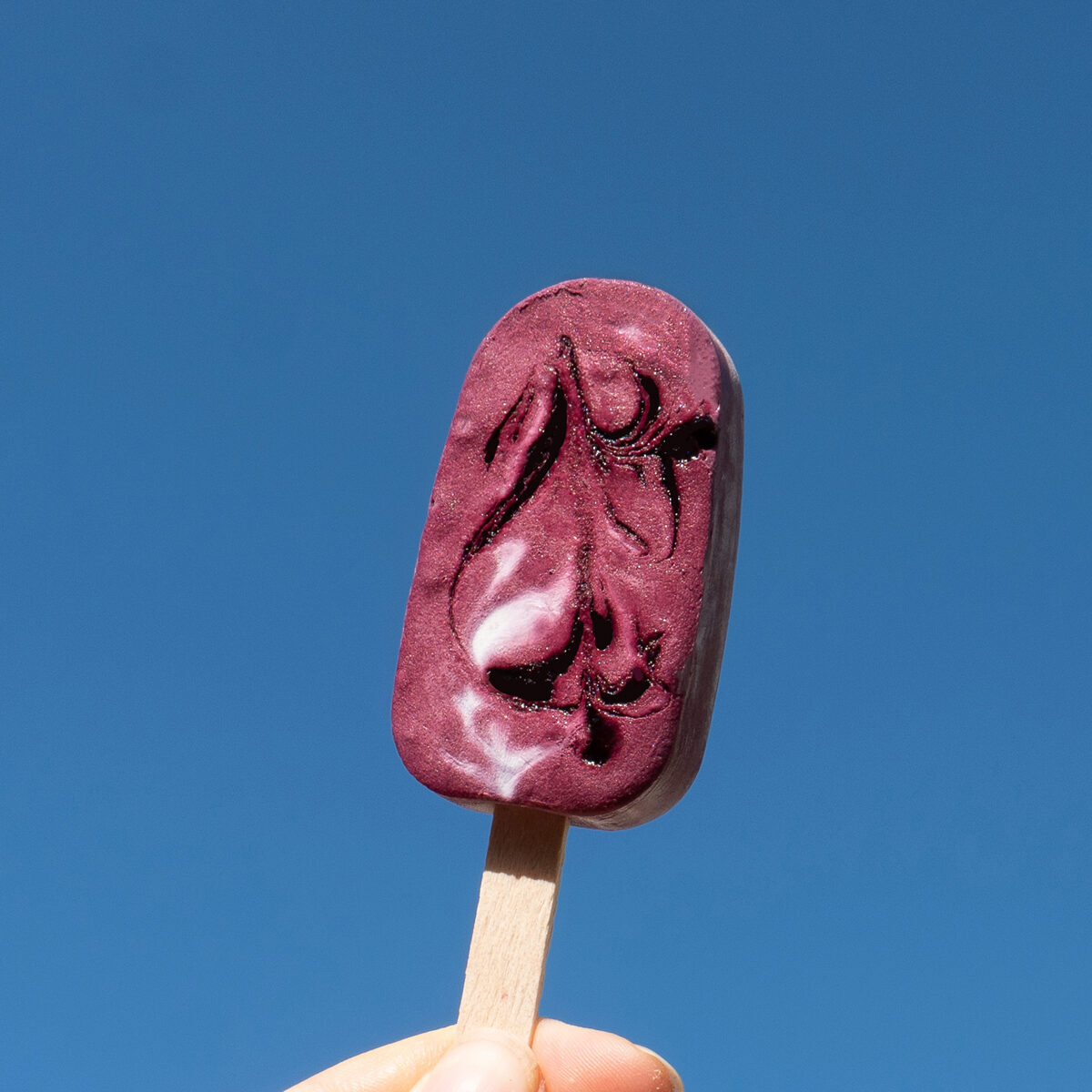 3 Popsicles Being Help Up In The Air