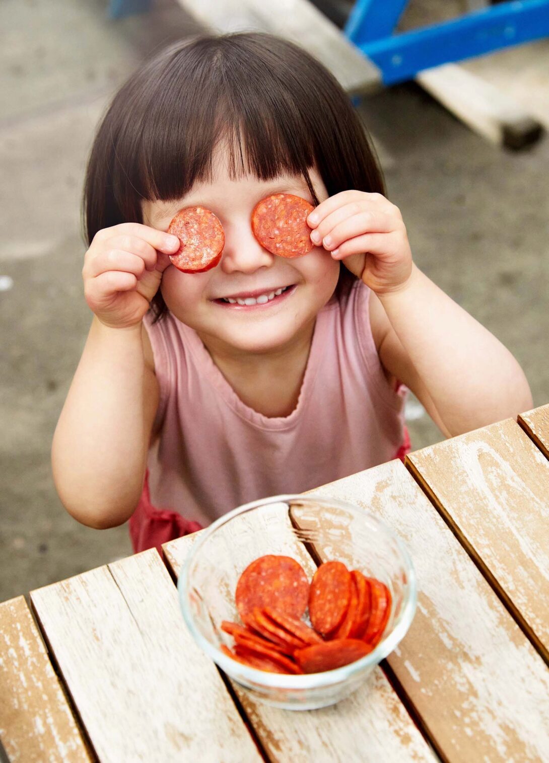 Nina with pepperoni over her eyes
