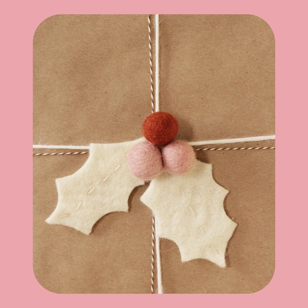 wrapped package with felt holly leaf adornment