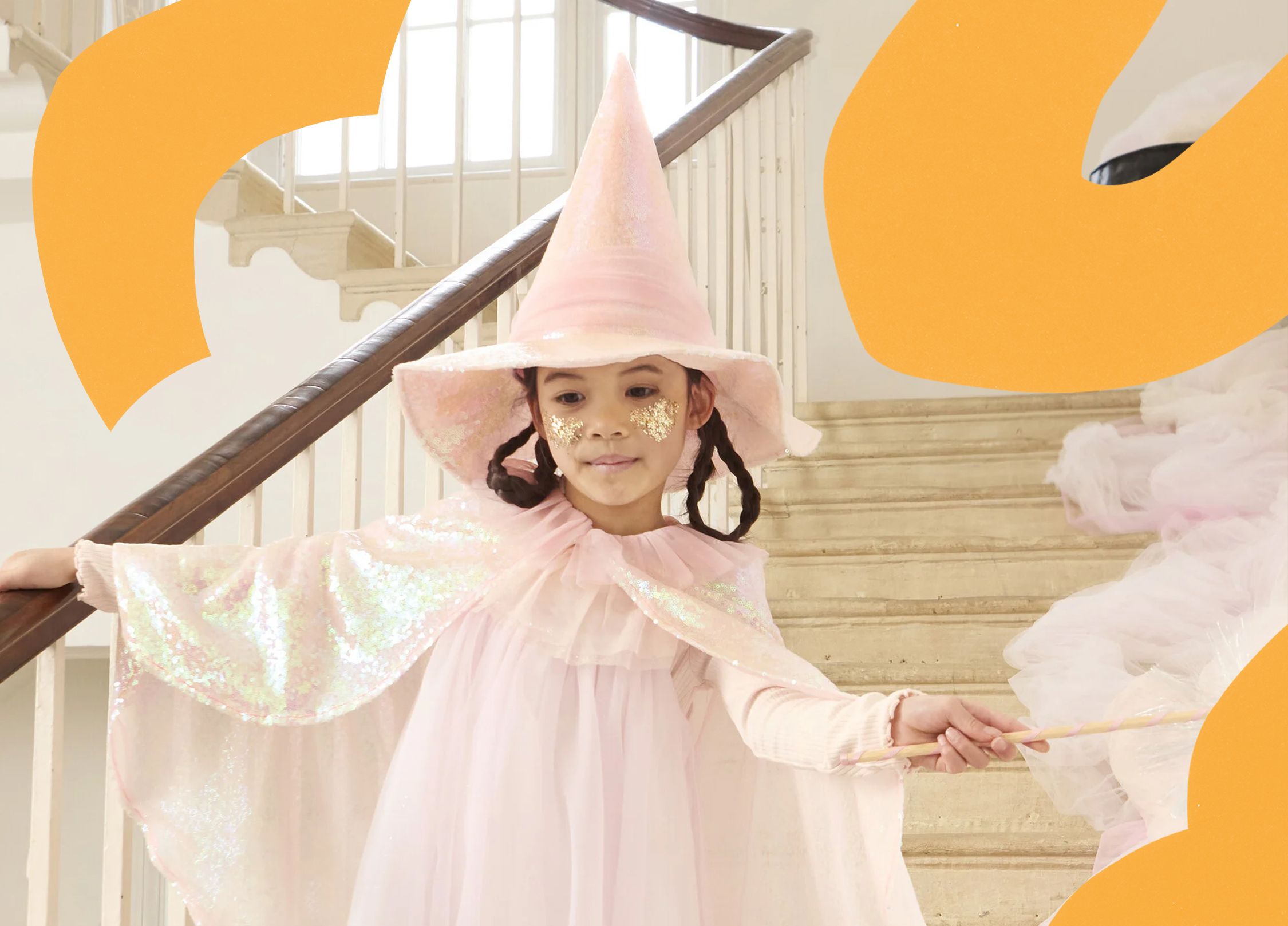 A young girl in a pink sparkly witch's hat.